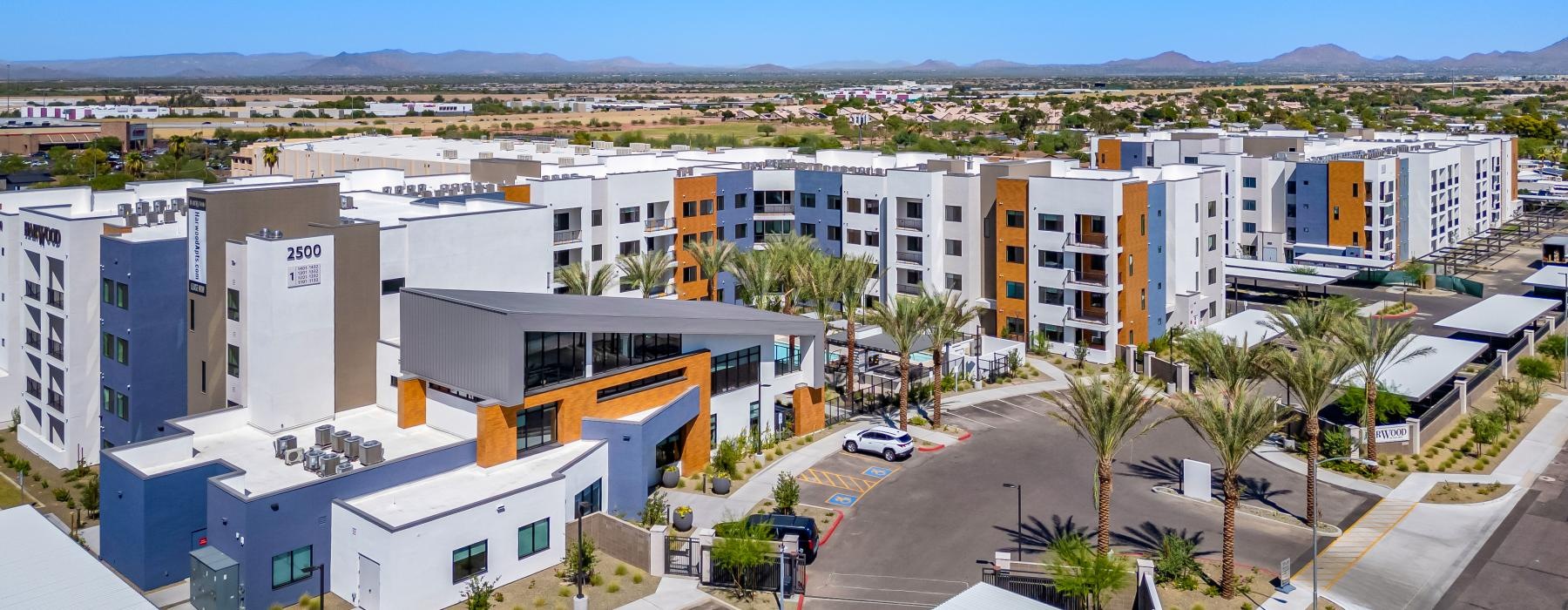 Find your perfect fit at Harwood a group of buildings with trees and a blue sky