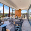 Outdoor lounge area with seating and a fireplace