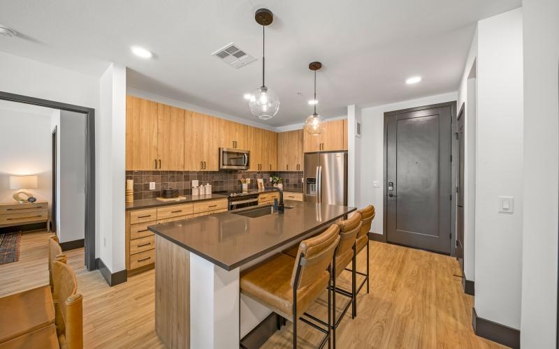 a kitchen with an island and seating