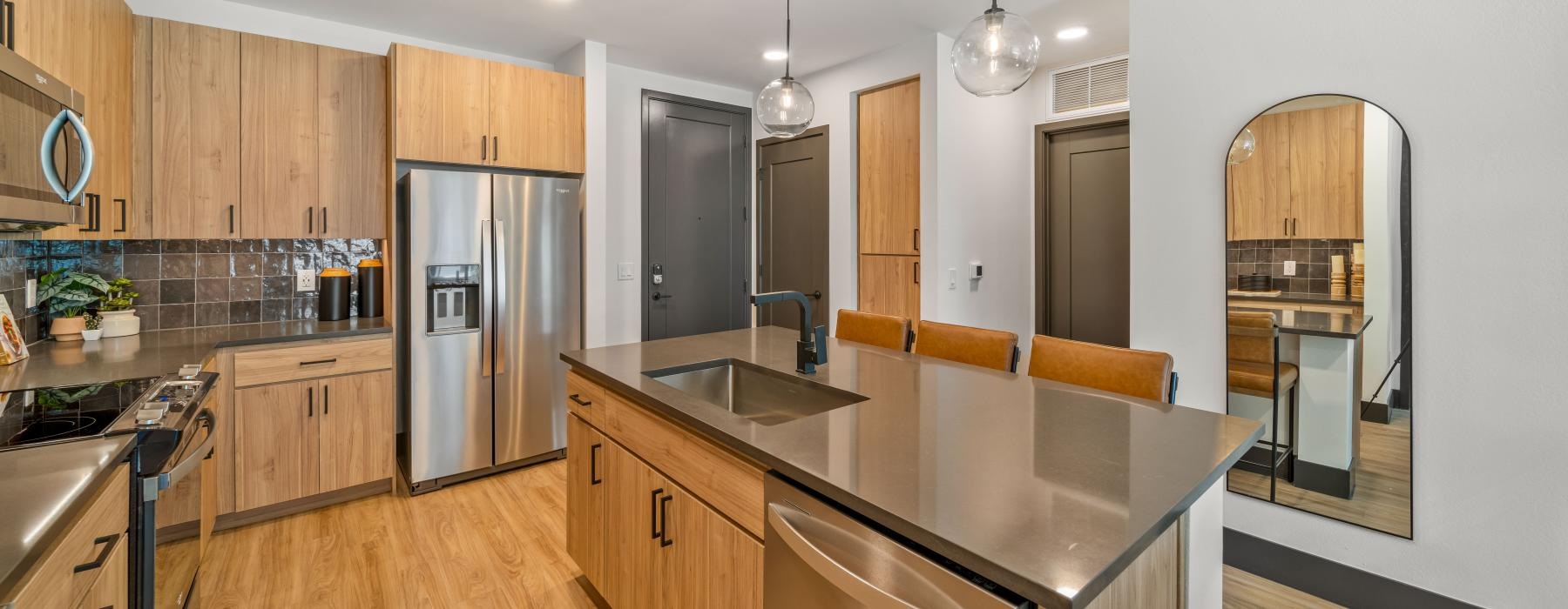 a kitchen with wooden cabinets and an island